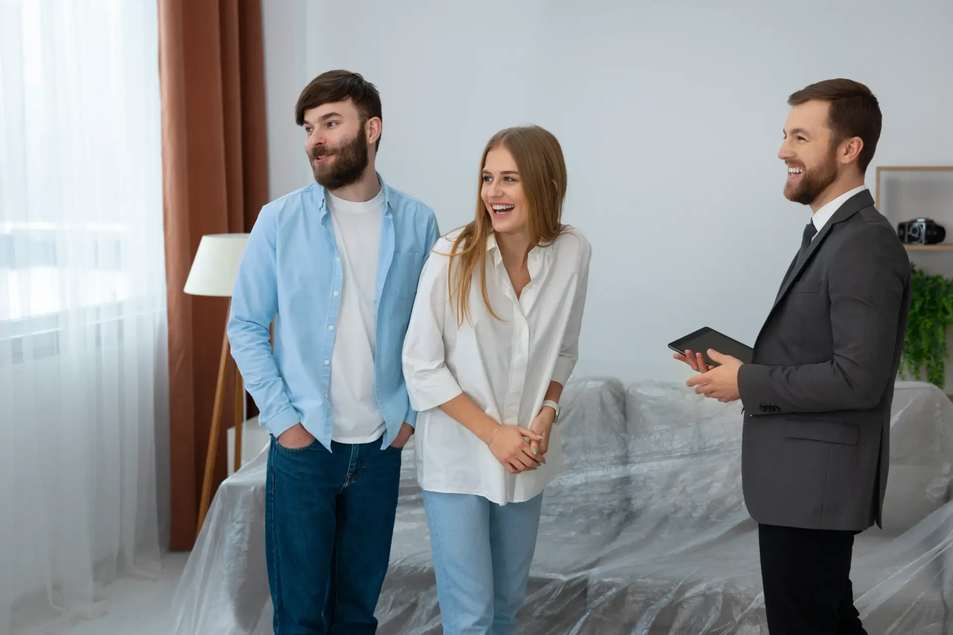 Smiling couple and a Real Estate Expert in Arlington WA viewing a new house.